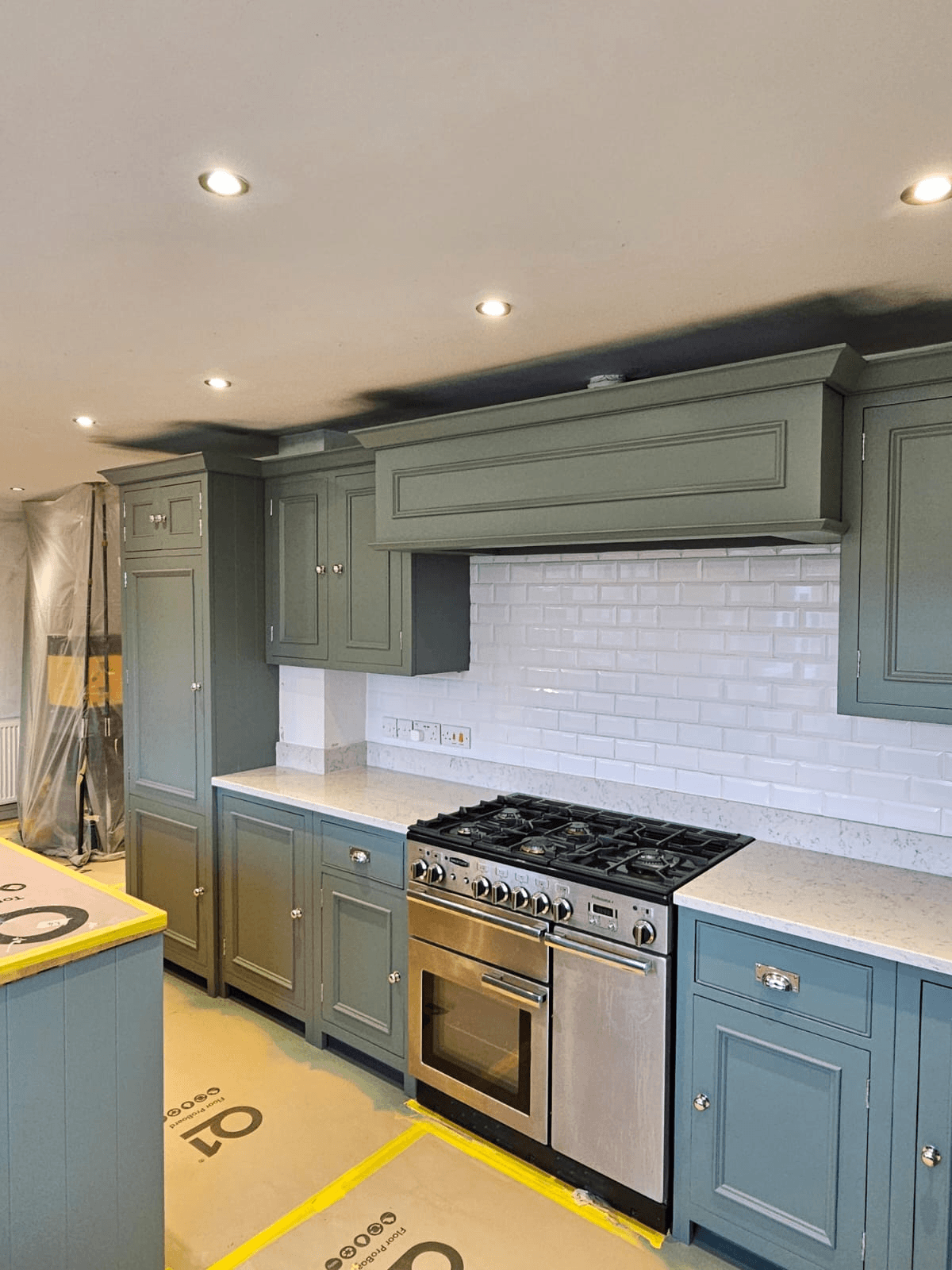 Kitchen respray Sheffield — completed dark green finish with white metro tiles