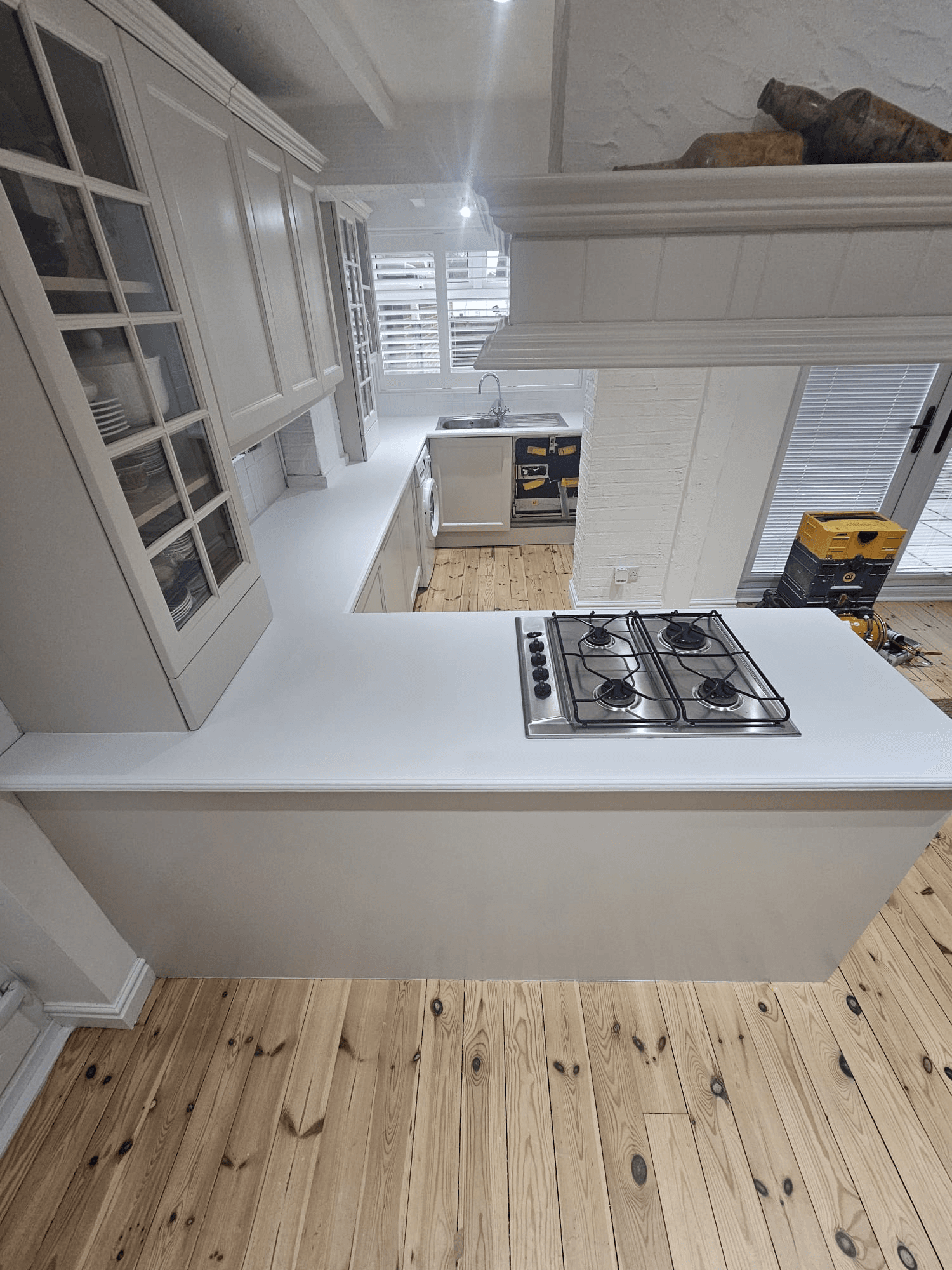Kitchen respray Sheffield — white kitchen with island and gas hob worktop