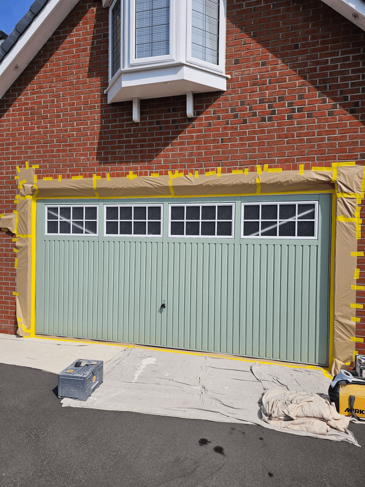 Garage door spraying Sheffield — sage green colour change in progress
