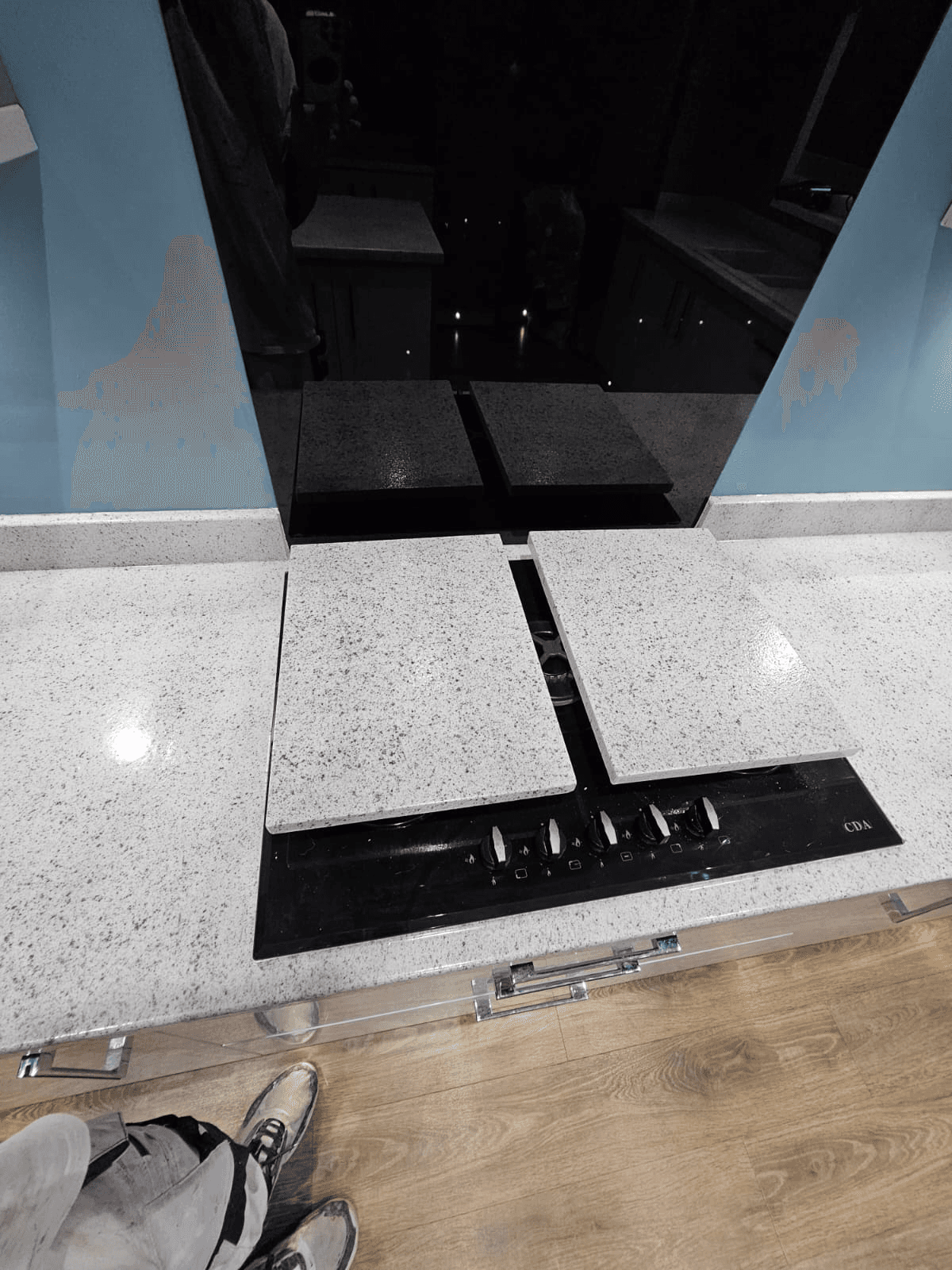 Kitchen worktop spraying Sheffield — white granite resin hob area detail